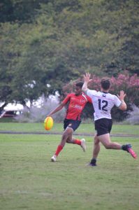 Rugby player in the process of kicking the ball